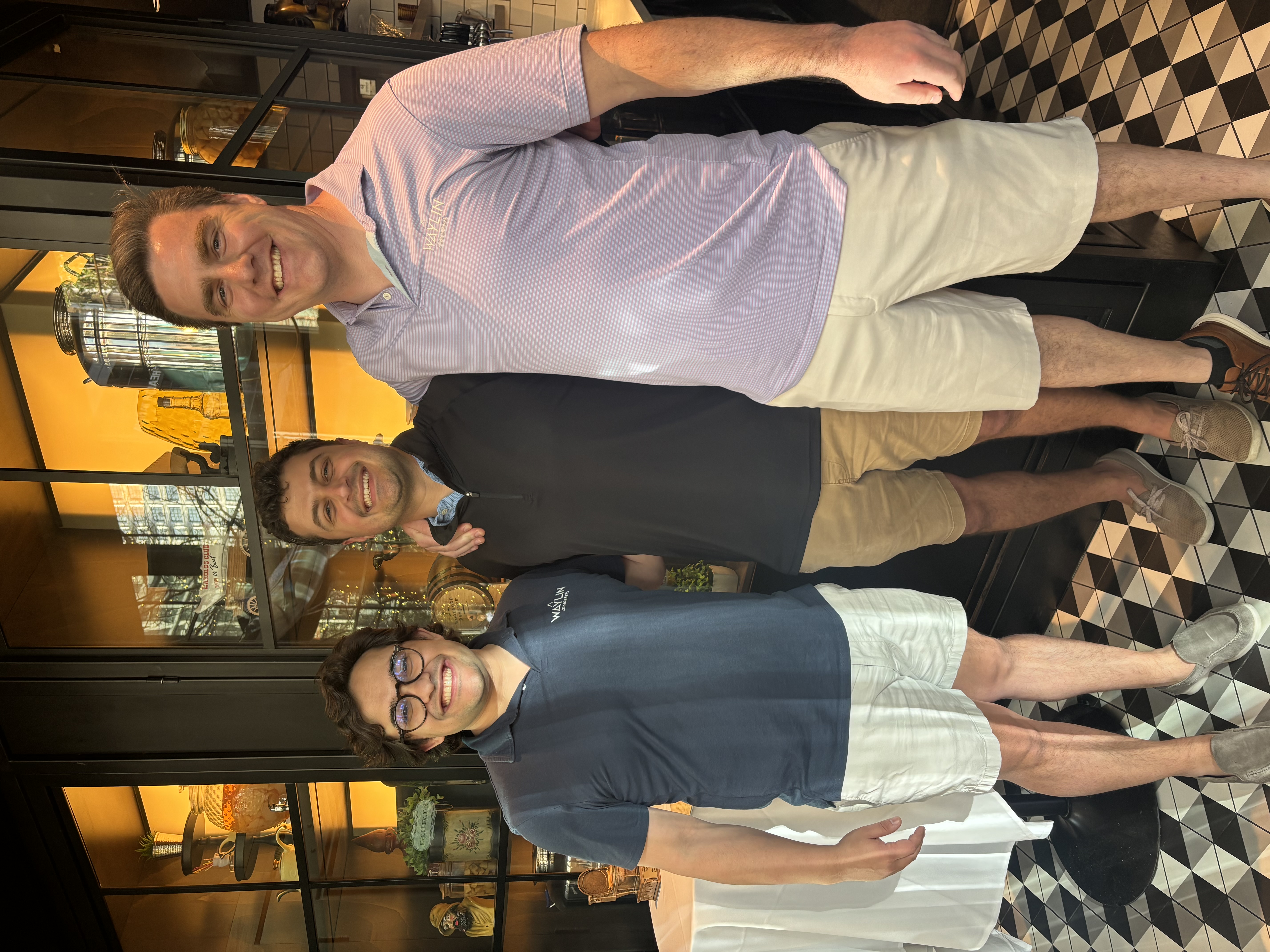 Three Waylin Partners team members at a group dinner during the Tampa offsite